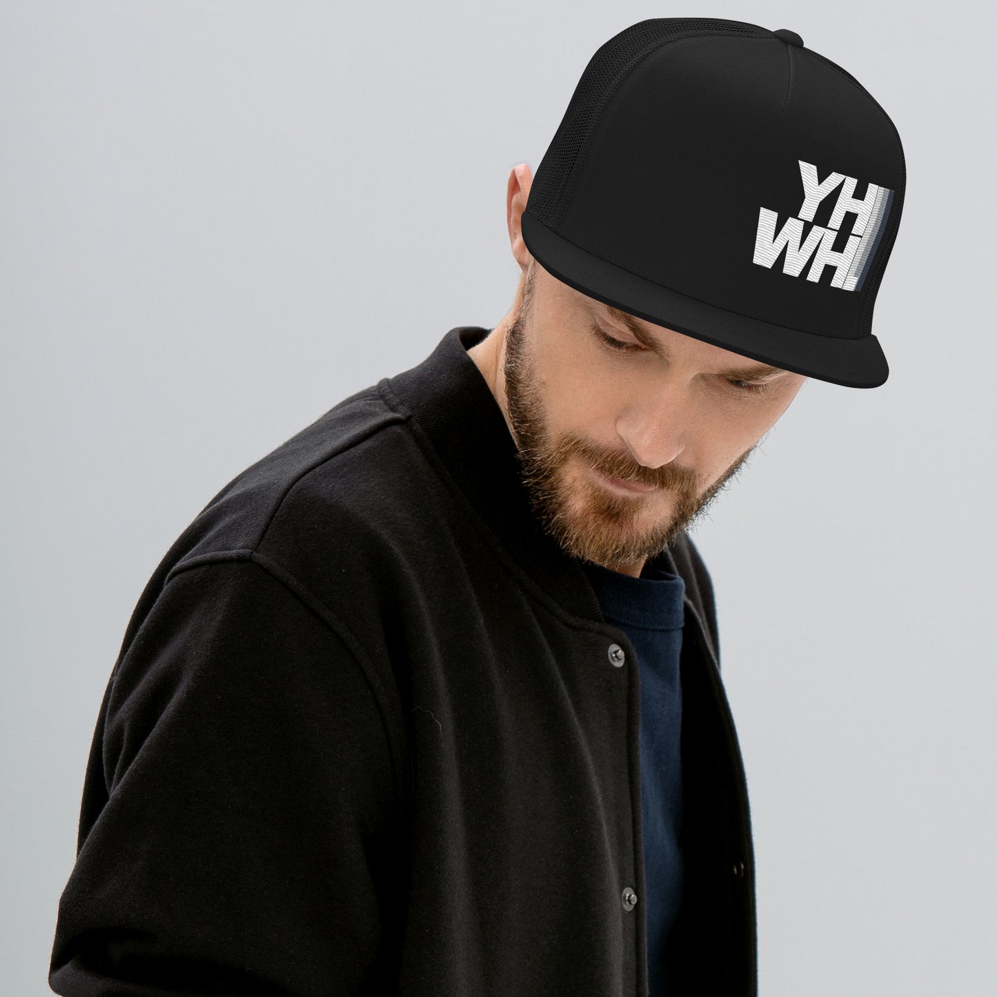 Model wearing the YHWH Unisex Trucker Cap, showcasing its stylish look and structured fit. A great choice for those who value their christian faith and support veteran-owned small businesses.