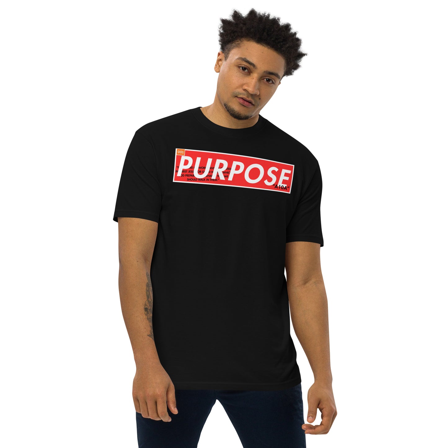 Purpose Premium Unisex T-Shirt held by a model, featuring a striking 'Purpose' logo. This tee blends style and inspiration for those who believe in their mission. Support this Christian, premium apparel from a veteran-owned small business.