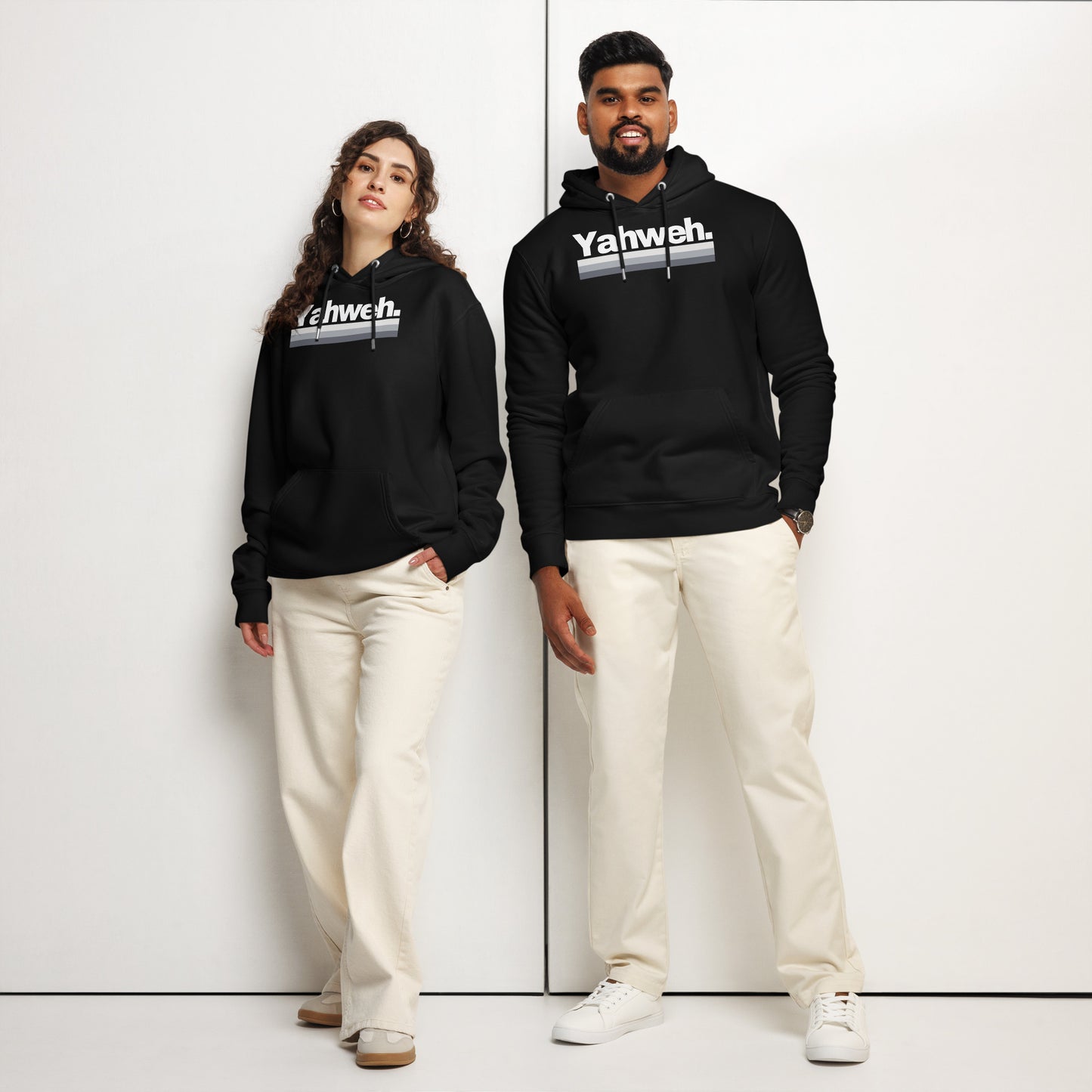 A stylish couple wears the YHWH Oversized Unisex Hoodie in black showcasing the 'Yahweh' design, ideal for those who value faith and individuality. This ensemble promotes support for a veteran-owned small business with a flair for street style.