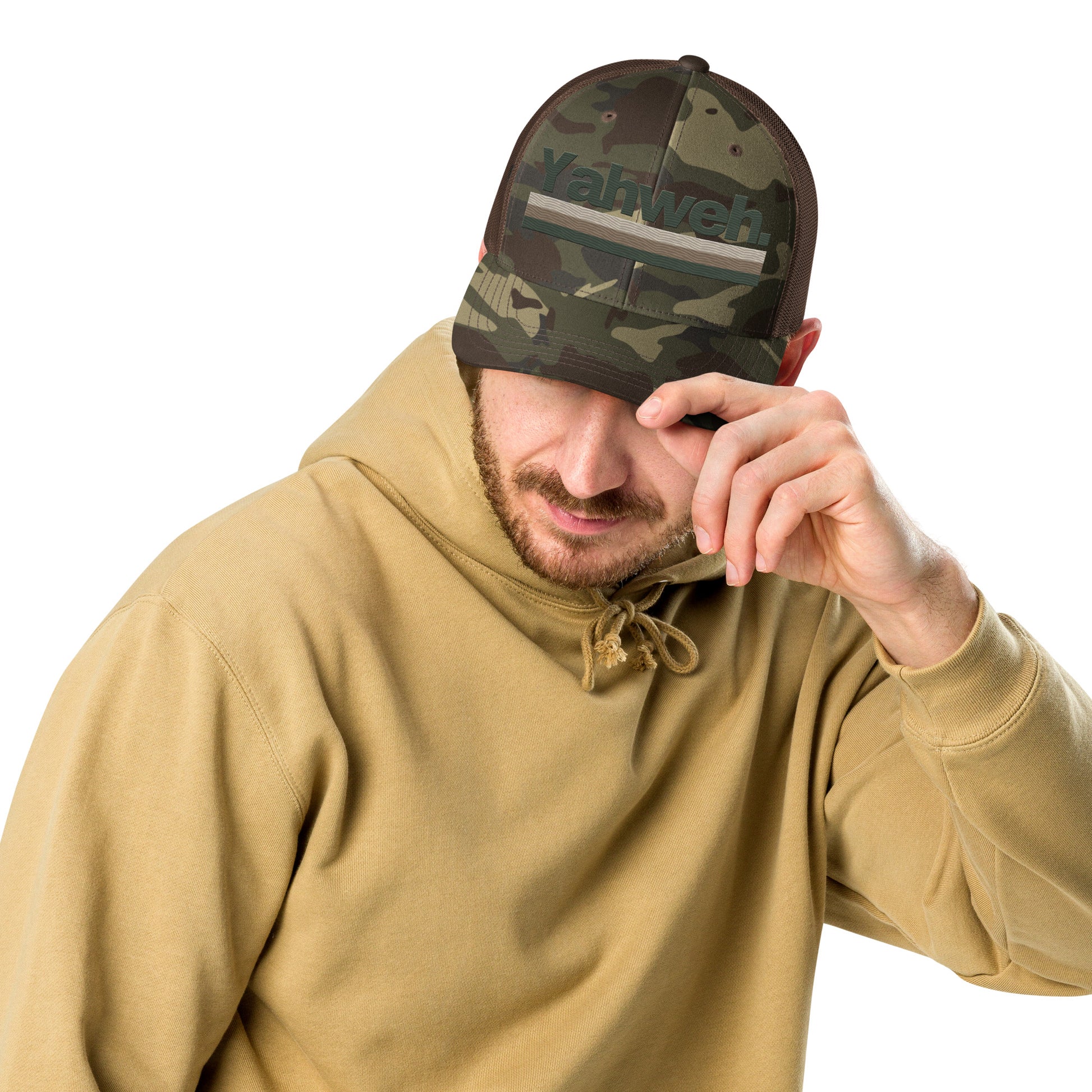 Man wearing the YHWH Camouflage Trucker Hat for Men - Structured Snapback with Embroidered Design, showcasing a casual look that blends fashion and faith. A great way to support small business and connect with the Christian community.