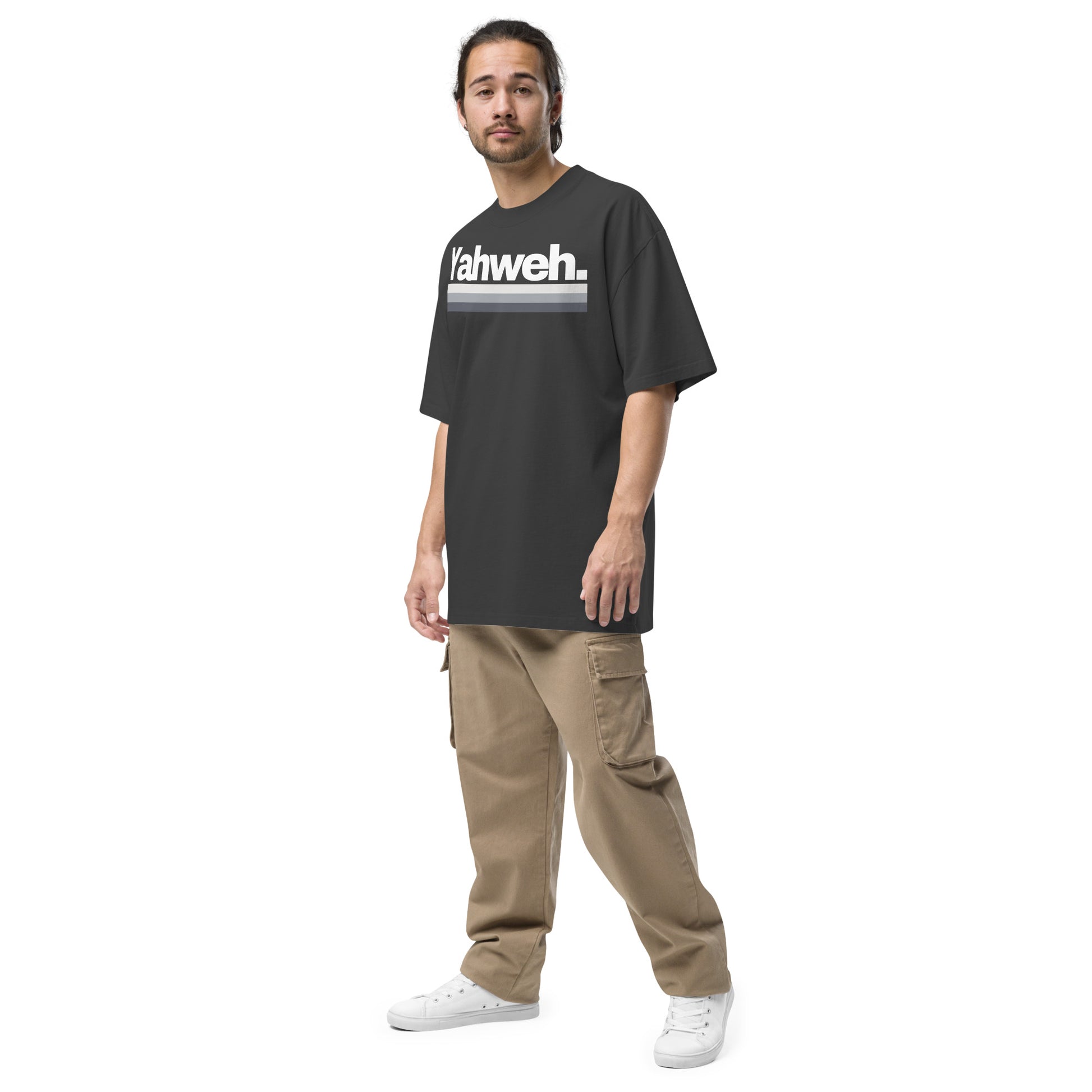 Model wearing the YHWH Oversized Unisex Faded T-Shirt, combining streetwear aesthetics with comfort and faith in a casual style. Proudly support this small business and its veteran ownership.